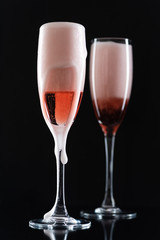Rose champagne in a glass on a black background