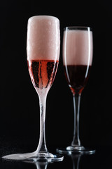 Rose champagne in a glass on a black background