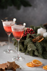 Rose champagne in a glass on the background of a Christmas wreath