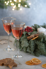 Rose champagne in a glass on the background of a Christmas wreath