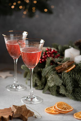 Rose champagne in a glass on the background of a Christmas wreath
