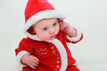 Close up Portrait of Cute Little 8 Month Old Baby Girl  with Big Blue Eyes, in Santa Claus Outfit, Happy and Healthy Baby, Santa Baby