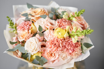 European floral shop. Beautiful bouquet of mixed flowers in glas vase. the work of the florist at a flower shop. Delivery fresh cut flower.