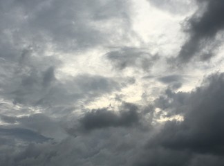 a low angle shot on the dramatic sky, with strong light coming through dark clouds after heavy rain
