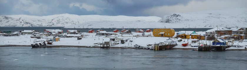 The polar village of Terebirka on a cloudy February day. Murmansk region, Russia