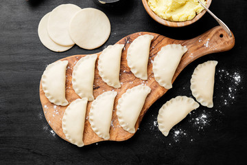 Homemade raw dumpling with potatoes. Preparation dumplings with mashed potatoes .