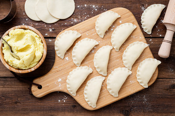 Homemade raw dumpling with potatoes. Preparation dumplings with mashed potatoes .