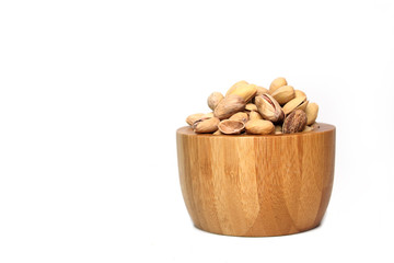 a bowl of pistachio nuts isolated on white background. Image contains copy space