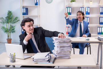 Two male colleagues unhappy with excessive work