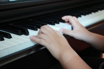 a little boy is playing the piano