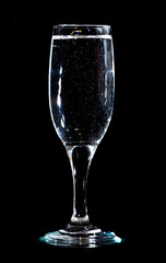 Water in a glass on a black background