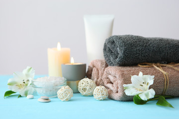 Fototapeta na wymiar spa composition with towels and flowers on the table with place for text. Body care, relaxation