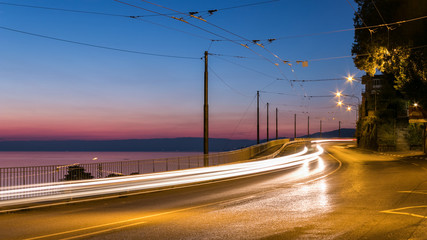 Fototapeta na wymiar Long exposure picture of a road next to an ocean in Montreux, Switzerland during sunset