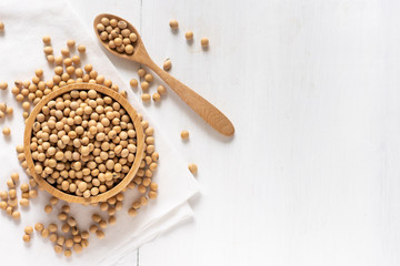 top view of soybean or soya bean in a bowl on white wooden background
