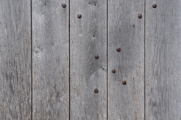 Old gray wooden plank with rusted nails