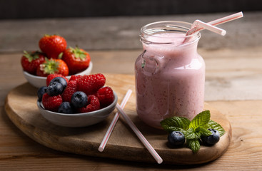 Red fruit smoothie. on a wooden table.