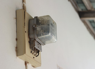 Kilowatt hour electricity meter on wall.