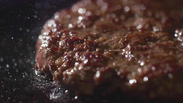 Cooking beef and pork patty for burger. Meat roasted at kitchen. Slow motion.