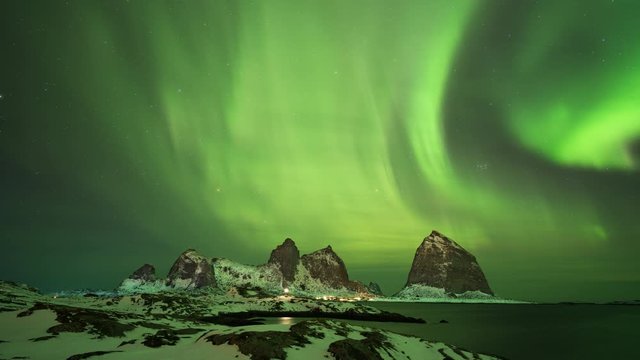 Time lapse of northern lights (aurora borealis) over iconic mountains of Sanna in Tr&aelig;na archipelago, Nordland, Norway