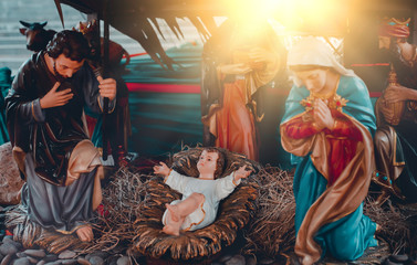 Traditional Christmas scenes and sacred light shining for use in illustration design Nativity scenes with Jesus baby on the manger with carvings, including Jesus, Mary, Joseph, sheep and magi © Ping198