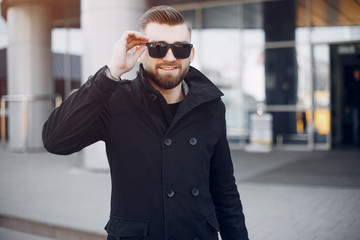 Man in a stylish suit. Businessman in a summer city