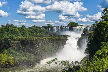 Famous Iguazu waterfalls with beautiful clouds. Declared a World heritage and one of the seven...