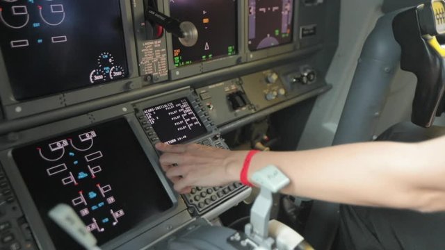 Pilot Inputting Flight Plan on an FMS in an Aircraft.