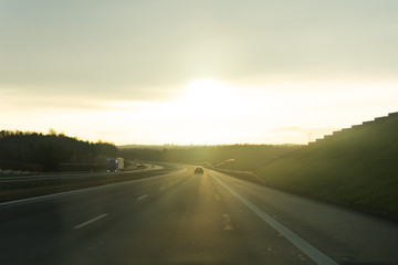 Fototapeta premium Sunrise on the road from the car window.