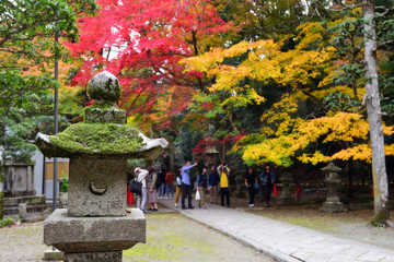 Osaka, Japan - November 24, 2019: Cement lantern with moss in the temple along the way to Minoo waterfall at Minoo park in Osaka, Japan