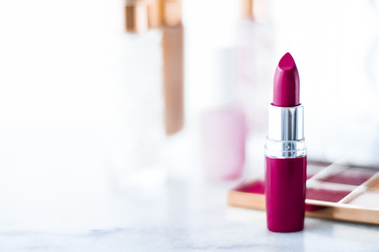 Cosmetics, makeup products on dressing vanity table, lipstick, foundation base, nailpolish and eyeshadows for luxury beauty and fashion brand ads design