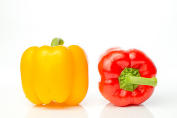Two red and yellow Fresh pepper are isolated in  white background.