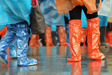 people with gaiters and rainproof raincoats during the rain