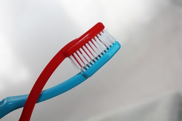 Red and blue toothbrush, one has bristles in the other, love or other topic concept