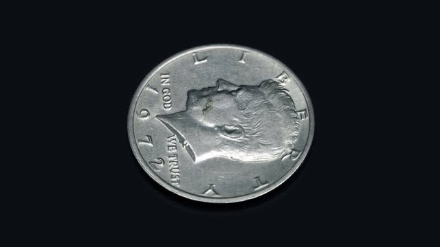 American coin half dollar 1972 release rotates on a black background. Macro. Closeup