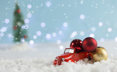 Christmas. Red decorative car with Christmas balls.Winter holiday. new-year. on a blue background...