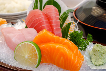 Closeup and crop Japanese Sashimi set on boat plate with Miso soup in Japanese bowl.
