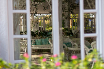 White furniture in the orangery among the decorations.