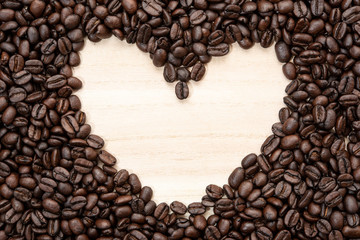 Heart-shaped frame of coffee beans. No edit.
