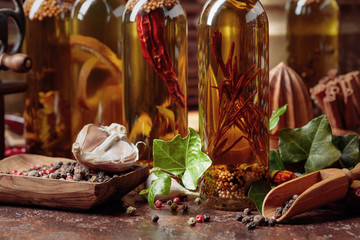 Bottles of olive oil with various spices.