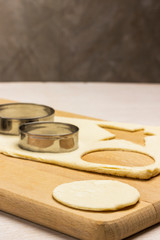 Dough for baking ginger cookies on cutting board,  form for cutting cookies,