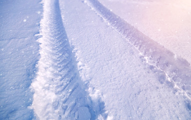 snowy winter road in a winter field in snowfall