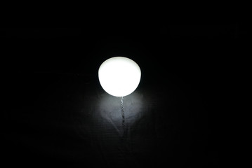 black background with a white light bulb