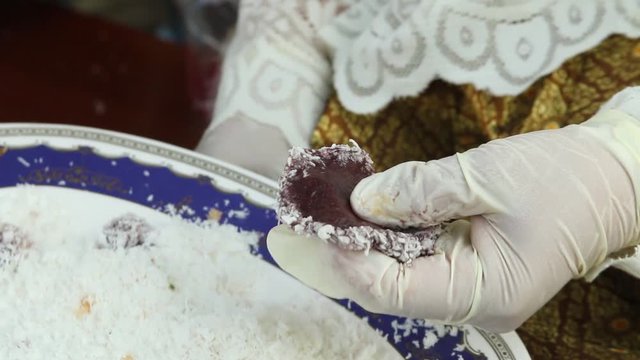 Thai dessert coconut, sugar and boiled minced shrimp wrap with sticky rice flour pad rolling in minced coconut : Kanom Tua Pab.