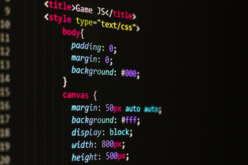html code on a black background on the monitor