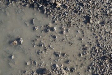 water puddle dirt road with small pebbles
