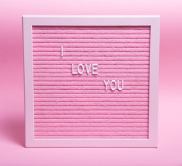 I love you made up of white letters on a pink Board on a pink background