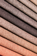 Colorful and bright fabric samples of furniture and clothing upholstery. Close-up of a palette of textile abstract stripes of different colors