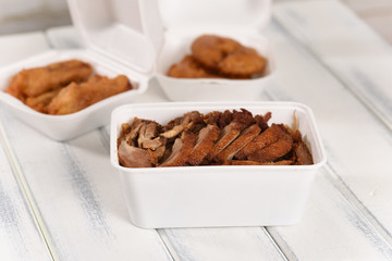 Fried Chinese duck, fast food in a plastic can