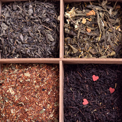 assortment of dry tea in a box for tea on a light background