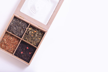 assortment of dry tea in a box for tea on a light background